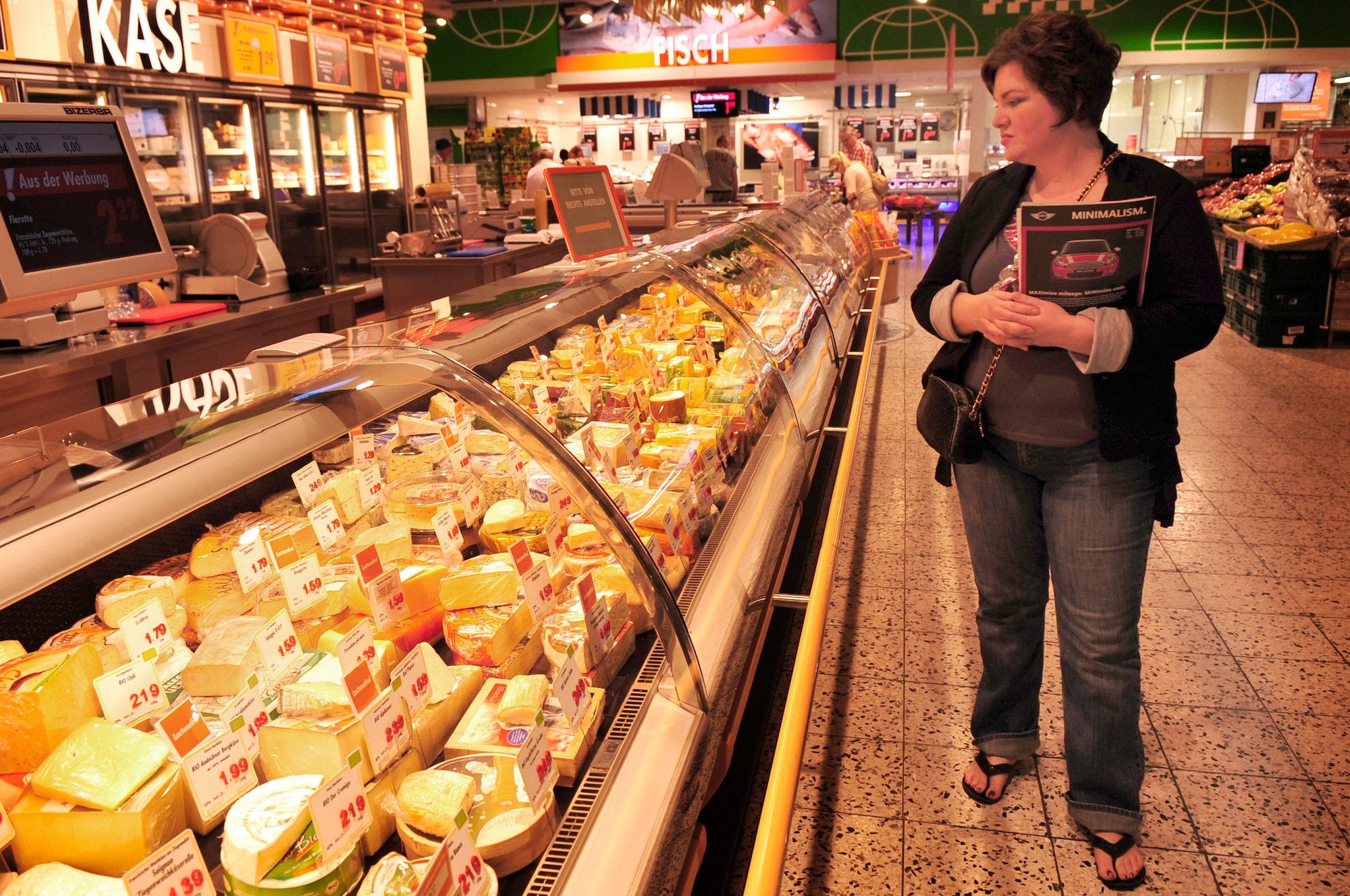 Melanie Robinson wife of Airman 1st Class Clark Robinson an information assurance technician with the 693rd Intelligence Support Squadron, looks at the cheese selection at a local grocery store during the first What is What class by the Airman & Family Readiness Center, May 26, 2011. "This tour has been extremely helpful, because normally just walking in would be intimidating," said Mrs. Robinson. The program was designed to give hands on experience to members of the Department of Defense in shopping on the local economy. (U.S. Air Force Photo by. Tech. Sgt. Jocelyn L. Rich)