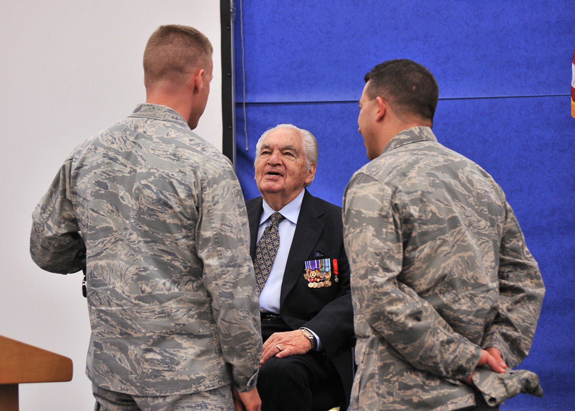 Former 303rd Bomb Group Radioman Eddie Deerfield talks with Air Force Colonels Jeffrey S. Yocum and Brian T. Kelly, Deputy Commander and Commander respectively of the 501st Combat Support wing after Deerfield’s talk at RAF Molesworth as part of the celebration of HELL’S ANGELS DAY on May 13th. (U.S. Air Force photo by Staff Sgt. Javier Cruz)