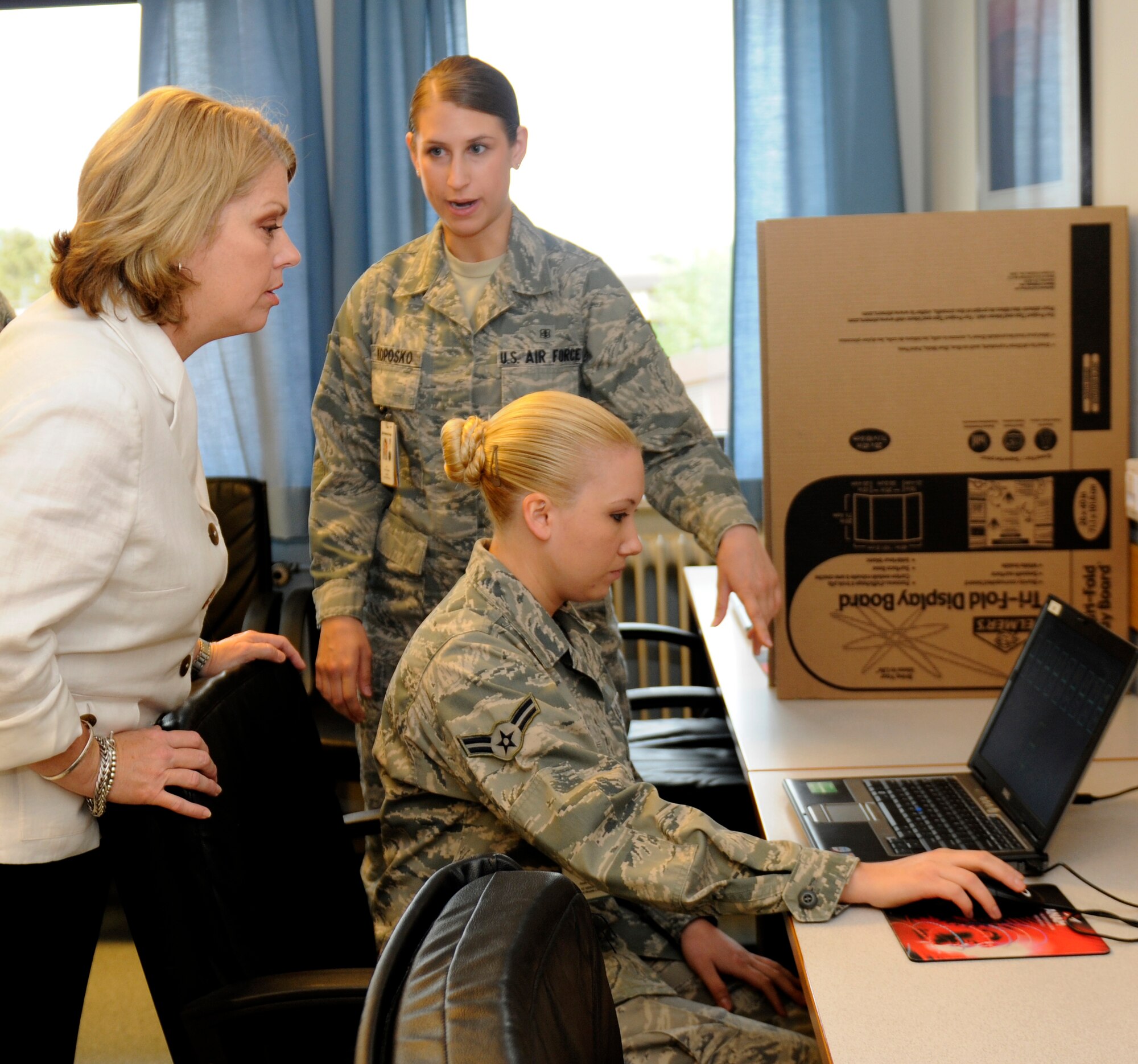 SPANGDAHLEM AIR BASE, Germany – Airmen 1st Class Allison Koposko and Anna White, both 52nd Medical Group mental health technicians, demonstrate to Sharon Gorenc, wife of Lt. Gen. Frank Gorenc, 3rd Air Force commander, how a memory test is performed here May 27. General and Mrs. Gorenc visited various facilities on Spangdahlem Air Base to improve their understanding of the base’s daily operations. (U.S. Air Force photo/Airman 1st Class Brittney Frees)