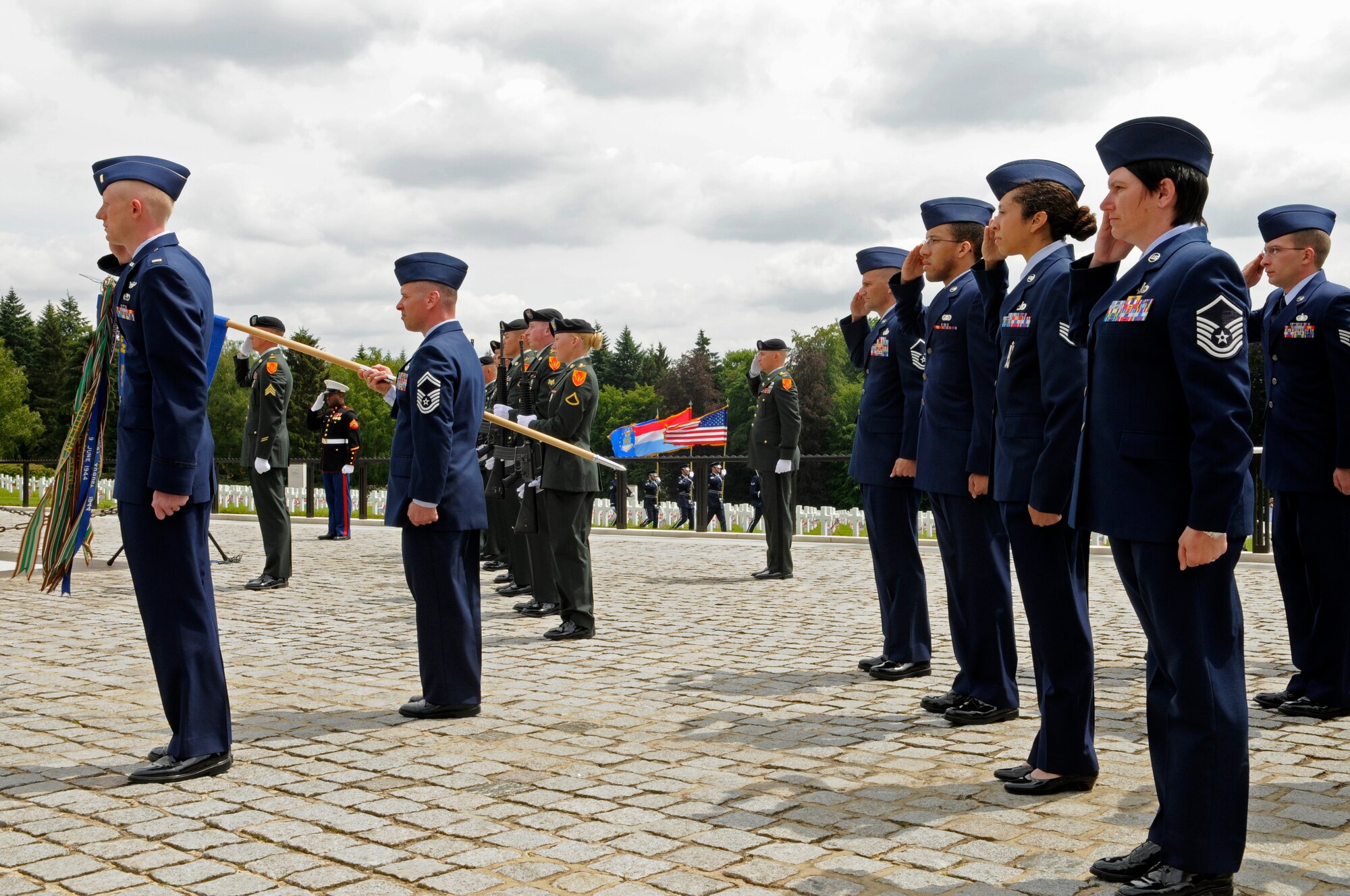 LUXEMBOURG – U.S. Airmen and Soldiers salute during the posting of the colors at a Memorial Day service at the Luxembourg American Cemetery and Memorial in Luxembourg May 28. The cemetery and memorial is the final resting place for more than 5,000 U.S. service members, including Gen. George S. Patton. (U.S. Air Force photo/Staff Sgt. Benjamin Wilson)