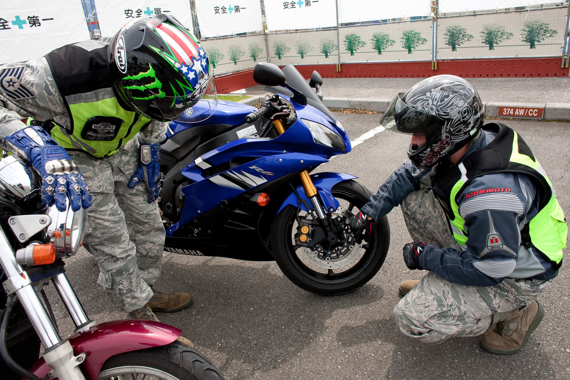 YOKOTA AIR BASE, Japan -- Tech. Sgt. Jason Scott, ground safety craftsman, (left) and Tech. Sgt. Scott Roberts, flight safety non-commissioned officer, both from the 374th Airlift Wing Safety office, inspect Sgt. Roberts' motorcycle before driving at Yokota Air Base, Japan, May 31, 2011. During the Critical Days of Summer campaign, base leadership urge all Airmen to exercise safe practices and make sound judgments on and off-duty. (U.S. Air Force photo/Osakabe Yasuo)
