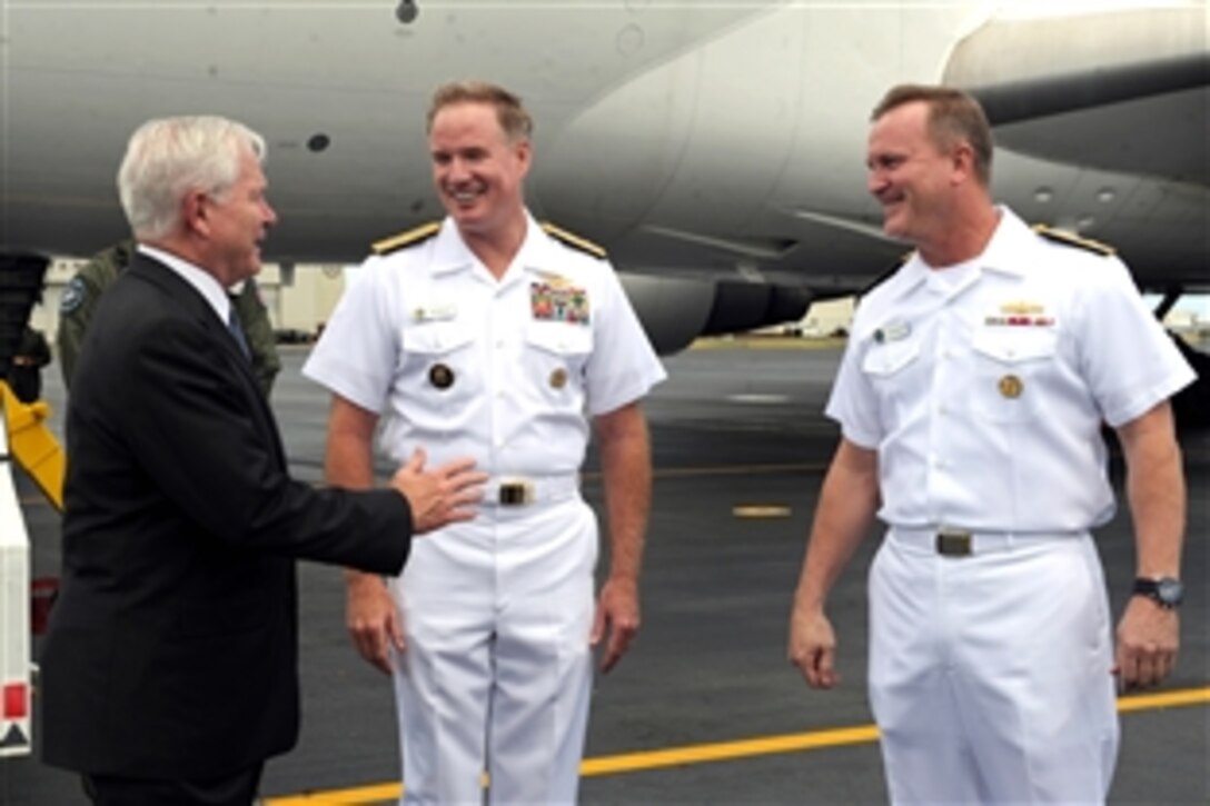 Defense Secretary Robert M. Gates meets with Navy Adm. Patrick Walsh, center, commander of U.S. Pacific Fleet, and Rear Adm. Thomas K. Shannon, right, deputy chief of staff for operations, training and readiness, upon his arrival in Hawaii, May 31, 2011. Gates visited the memorial while en route to Singapore to attend the Shangri-La Dialogue, which begins later this week. 