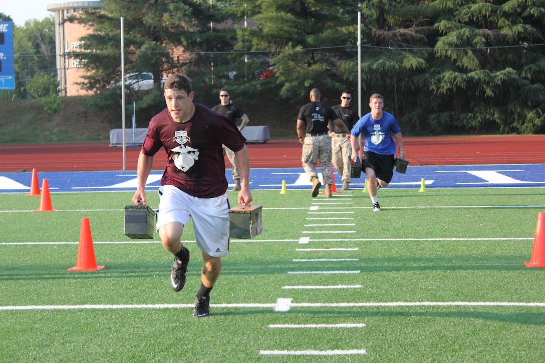 Student-athletes at the Chaattanooga Junior Rank Diamond Flight football camp run with ammo cans as part of their Marine-led physical training session June 2. One hundred of the best high school football players in the country, some of whom attended Diamond Flight camps during the summer, will be competing in the inaugural Semper Fidelis All-American Bowl in Phoenix Jan. 3, 2012.