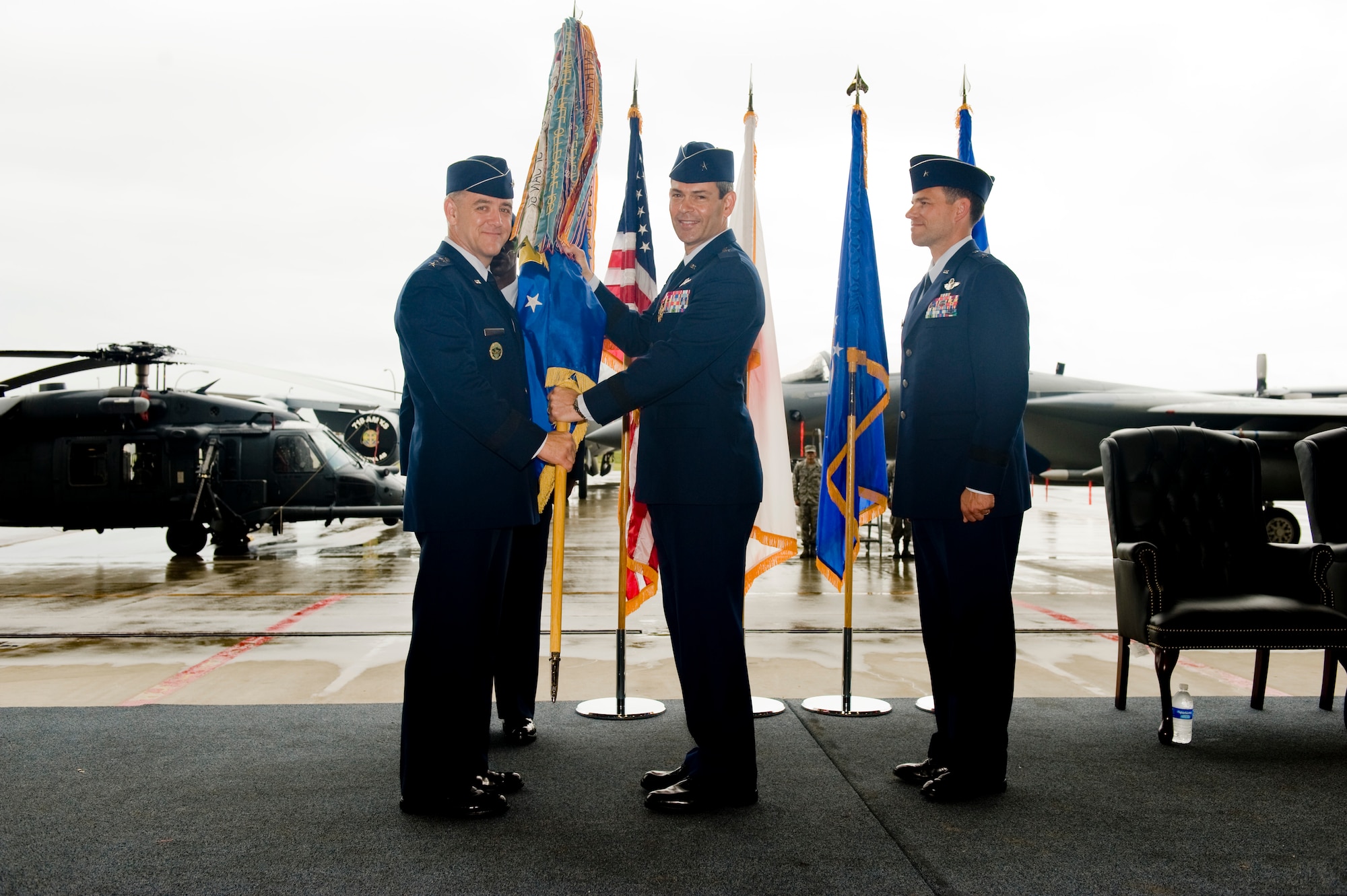 Brig. Gen. Ken Wilsbach, former 18th Wing commander, passes the guidon to Lt. Gen Burton Field, 5th Air Force Commander, during the 18th Wing change of command ceremony, at Kadena Air Base, June 3. General Wilsbach relinquished his command to Brig. Gen. Matt Molloy and is heading to Camp H.M. Smith, Hawaii to assume the position of deputy director for operations, Headquarters United States Pacific Command. (U.S. Air Force photo/Staff Sgt. Jonathan Steffen)
