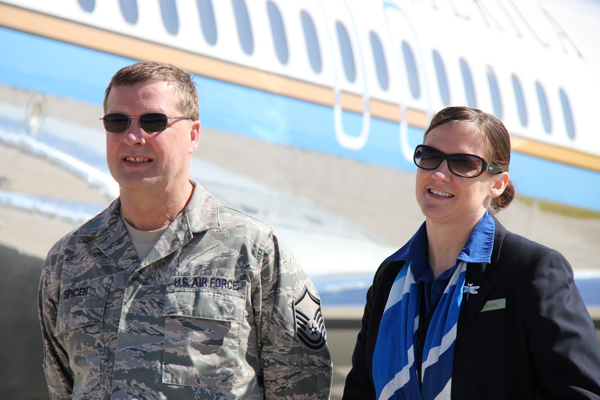 Master Sgt. Mark Spicer, maintainer, and Tech. Sgt. April Tarbill, flight attendant, meet on the brightly-lit flightline to talk issues and get ready for a mission aboard the 932nd Airlift Wing C-9C plane belonging to Air Force Reserve Command.  The 932nd Airlift Wing takes care of maintaining and flying the aircraft throughout the year.  (U.S. Air Force photo/Maj. Stan Paregien)