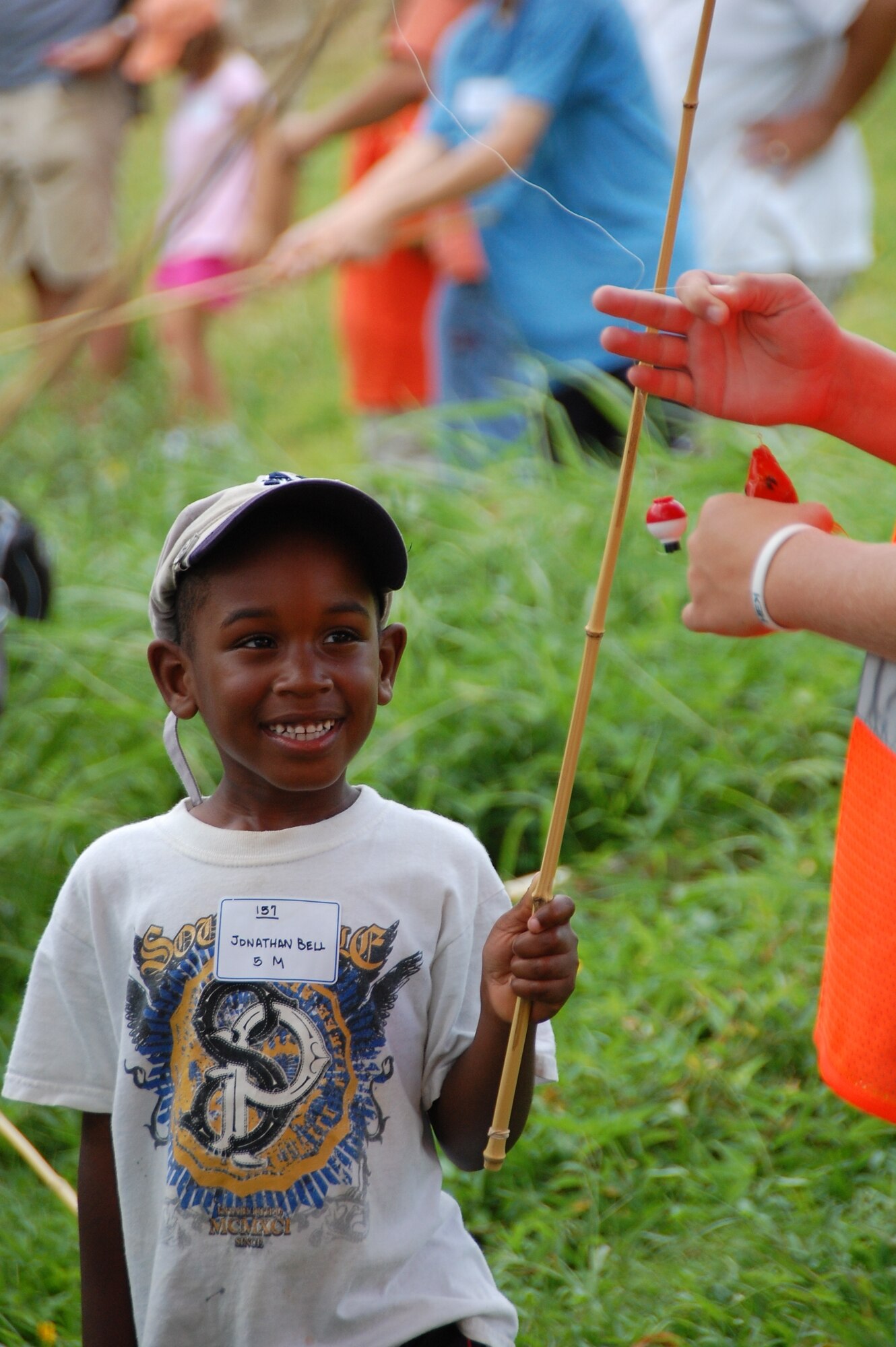 Jonathan Bell beams as a volunteer checks his catch at the Friends of Hickam 12th Annual Keiki Fishing Tournament at Ho'omaluhia Botanical Garden June 1. (U.S Navy Photo/Chris Aguinaldo) 

