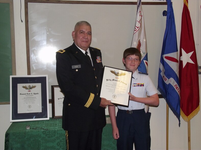 Brig. Gen. Paul Pena, New Mexico National Guard, left, awards Cadet 2nd Lt. Kyrie Selph the General Billy Mitchell Award for completing the second phase of the cadet program.

