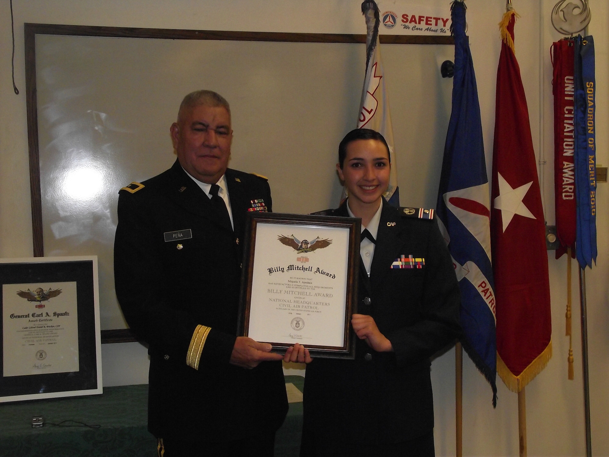 Brig. Gen. Paul Pena, New Mexico National Guard, left, awards Cadet 2nd Lt. Miquela Apodaca the General Billy Mitchell Award for completing the second phase of the cadet program.