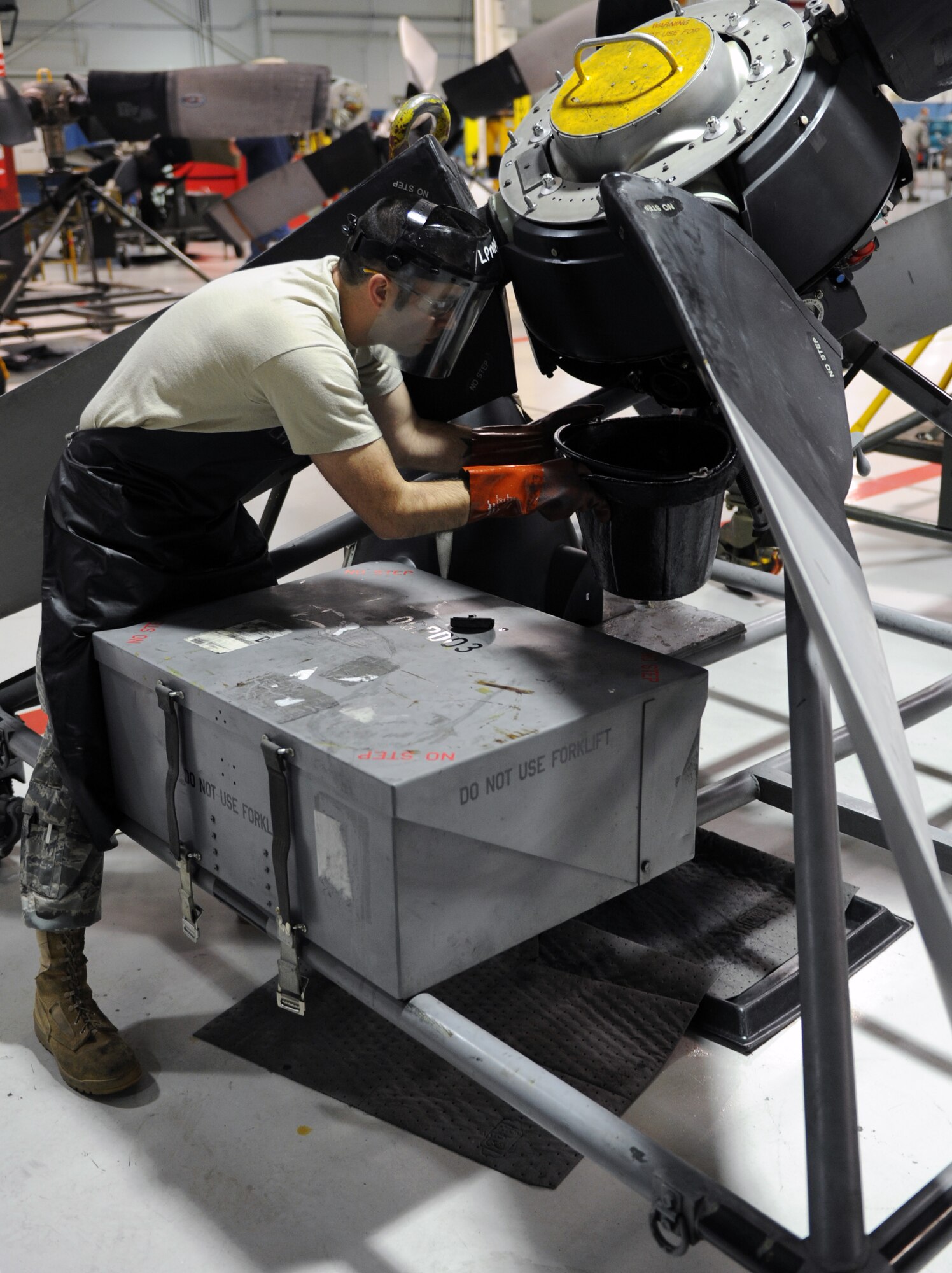 Senior Airman William McTavish, a 19th Component Maintenance Squadron aerospace propulsion journeyman, drains fluid out of a propeller control pump May 31, 2011, at Little Rock Air Force Base, Ark. Draining the fluid is one of the steps in the final inspection of a C-130 propeller. (U.S. Air Force photo by Airman 1st Class Rusty Frank)
