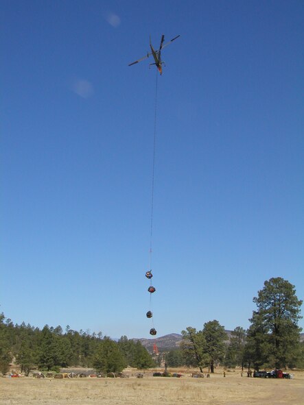 A K-Max heavy capacity helicopter lifts a load of cargo to be delivered to hotshot crews fighting along the fire line of the Miller Fire near Silver City.