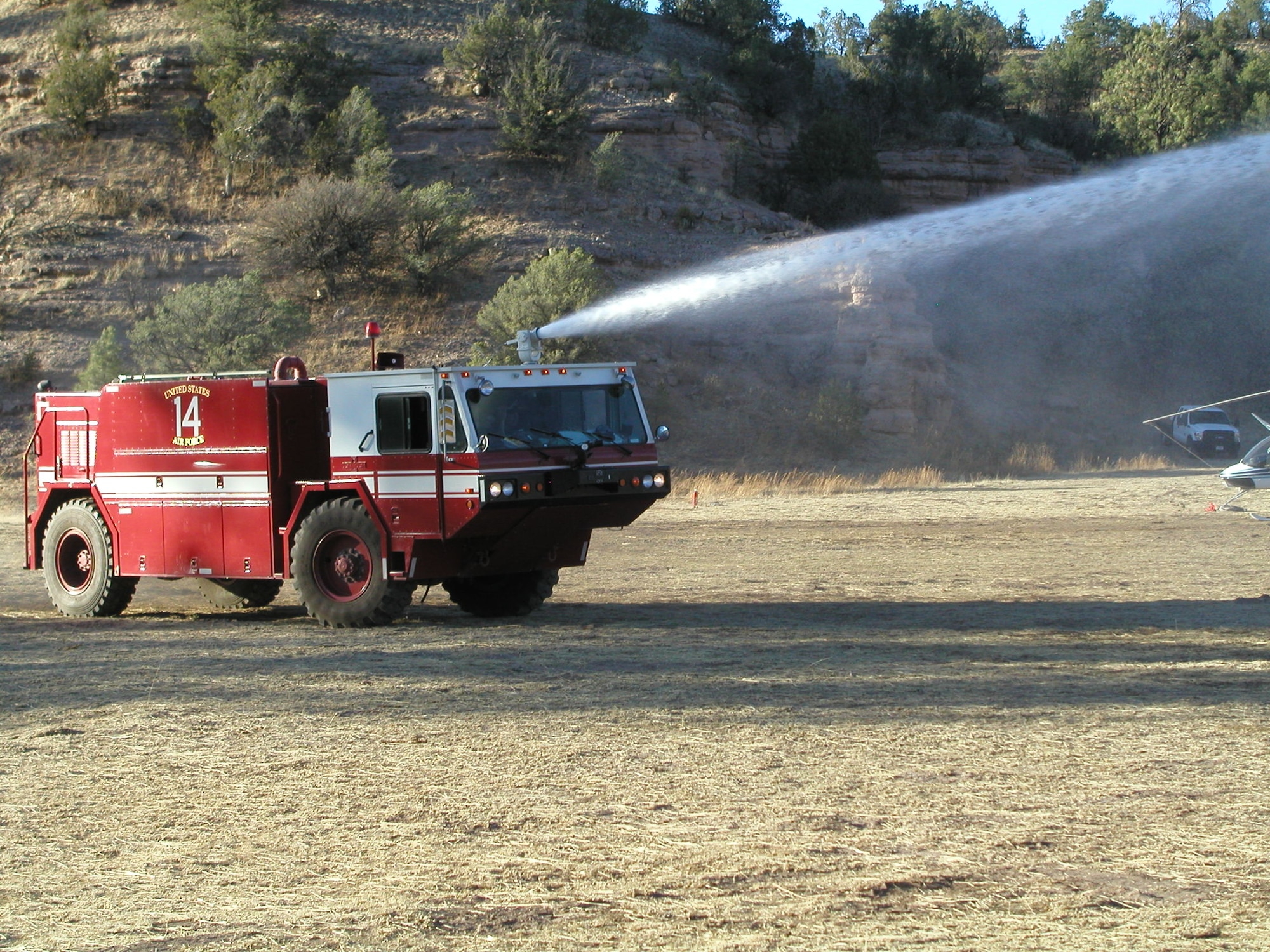 A Kirtland Air Force Base Crash-14 vehicle demonstrates its firefighting capability at the Celebration Helibase.