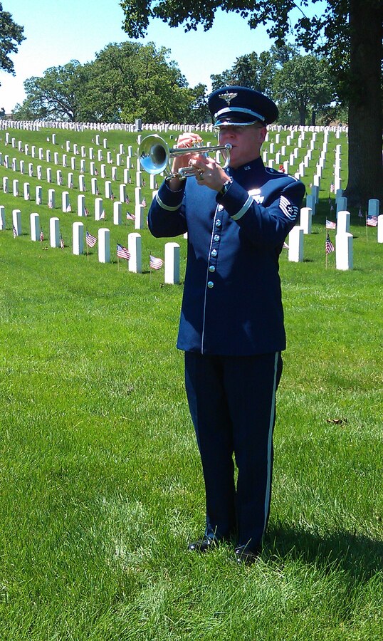 TSgt Scott Sauer plays ceremonial trumpet to honor fallen heroes during a Memorial Day ceremony at Jefferson Barracks, St. Louis, Missouri