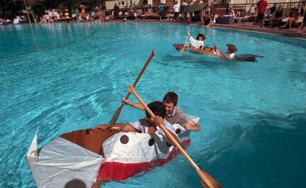 During the Fourth Annual Randolph High School Physics and PreCal Cardboard Boat Regatta,  Ryan Goodwin and John Byrd sail their pirate-themed cardboard boat while team Randolph Yacht Club: Munaum Qureshi and Austin Alderete, furiously paddle as they begin to sink during a race to the finish.
(U,S, Air Force photo/Brian McGloin)