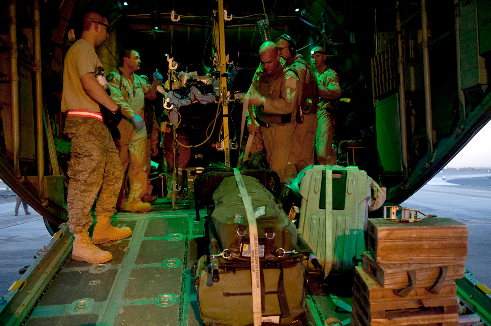 Members from the 451st Expeditionary Aeromedical Evacuation Squadron, Detachment 1, help secure wounded Marines, their baggage and medical equipment onto a C-130 Hercules on May 23, 2011, at Camp Bastion, Afghanistan. The CASF team is responsible for taking care of and transporting patients from the staging facility and role hospital to aircraft for transport to the next level of medical care. (U.S. Air Force photo/Master Sgt. Adrian Cadiz)
