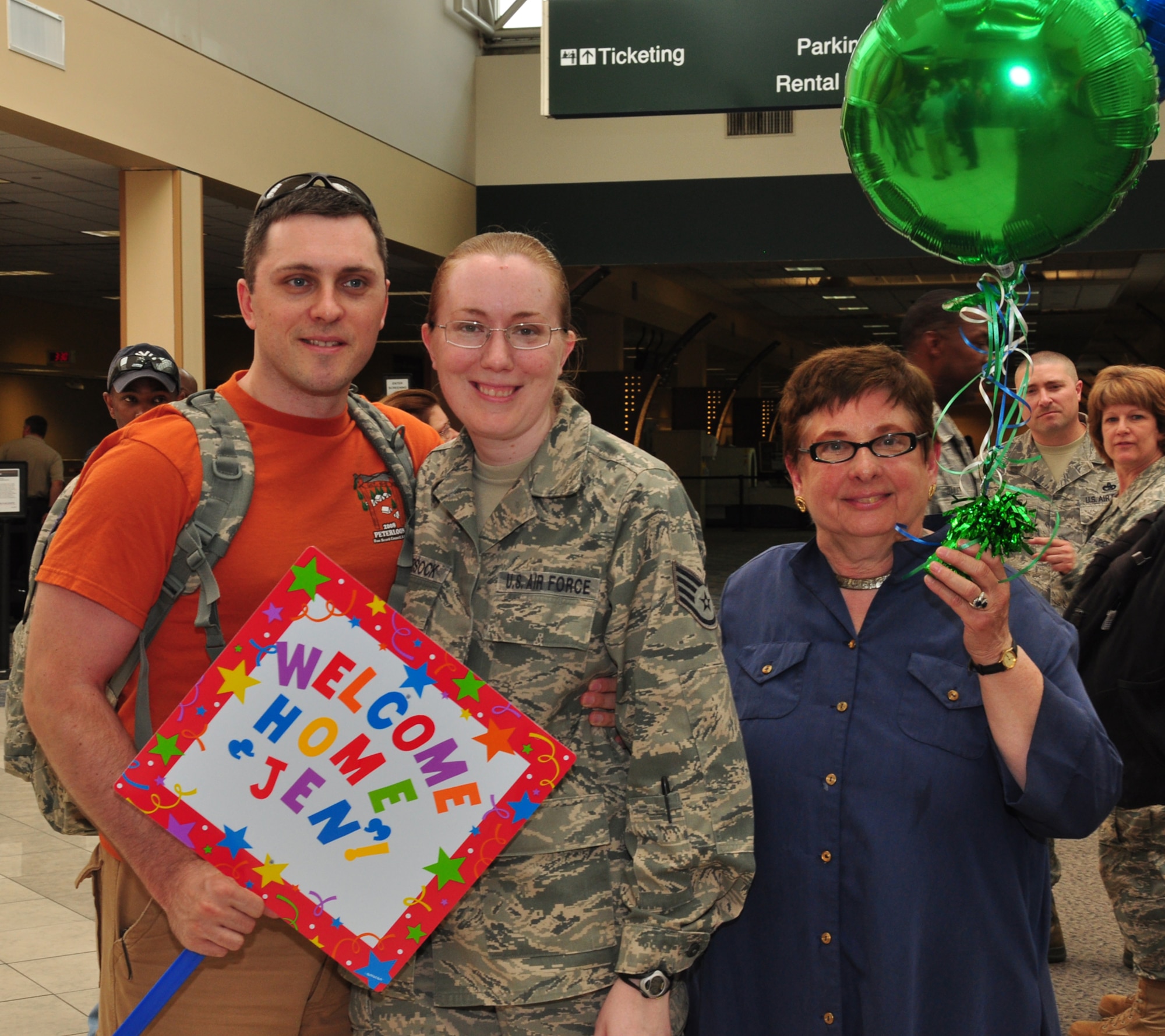 WRIGHT-PATTERSON AIR FORCE BASE, Ohio – Staff Sgt. Jennifer Bowersock, 87th Aerial Port Squadron, receives a warm welcome from her husband, Adam, and co-worker, Ann Koch, upon her arrival at the Dayton International Airport May 25 after returning from a  4-month deployment to Southwest Asia. (U.S. Air Force photo/Senior Airman Mikhail Berlin)