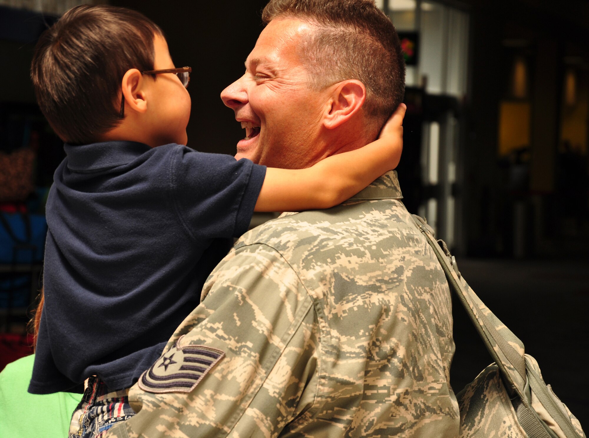 WRIGHT-PATTERSON AIR FORCE BASE, Ohio – Tech. Sgt. William Castle, 87th Aerial Port Squadron, hugs his son at the Dayton International Airport May 24 after returning from a 4-month deployment to Southwest Asia. (U.S. Air Force photo/Senior Airman Mikhail Berlin)