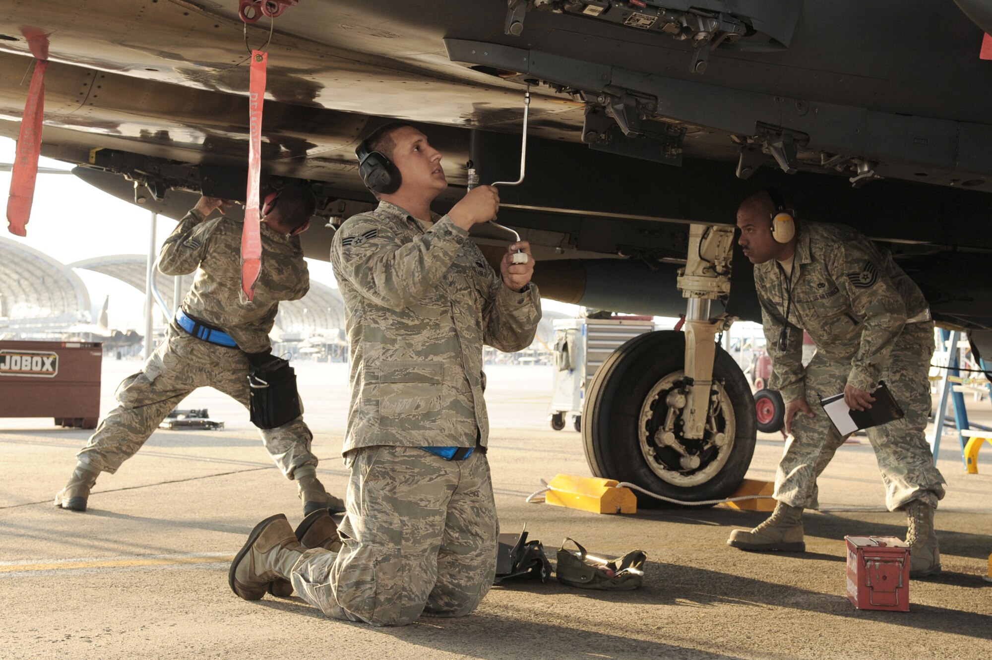 Members of the 4th Aircraft Maintenance Squadron perform maintenance operations during a weapons load competition May 25, 2011, at Seymour Johnson Air Force Base, N.C. (U.S. Air Force photo/Senior Airman Whitney Lambert)