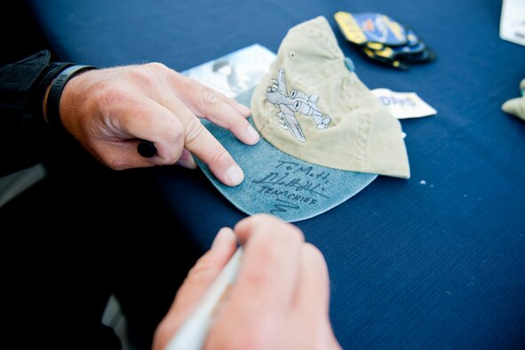 JONES BEACH STATE PARK, N.Y. -- Master Sgt. Matthew Harris, A-10 East Demonstration Team chief, signs a hat for an air show enthusiast May 29. During this year’s air show season, the demo team is scheduled to perform at 32 venues around the world. (U.S. Air Force photo/Staff Sgt. Jamal D. Sutter)(RELEASED)