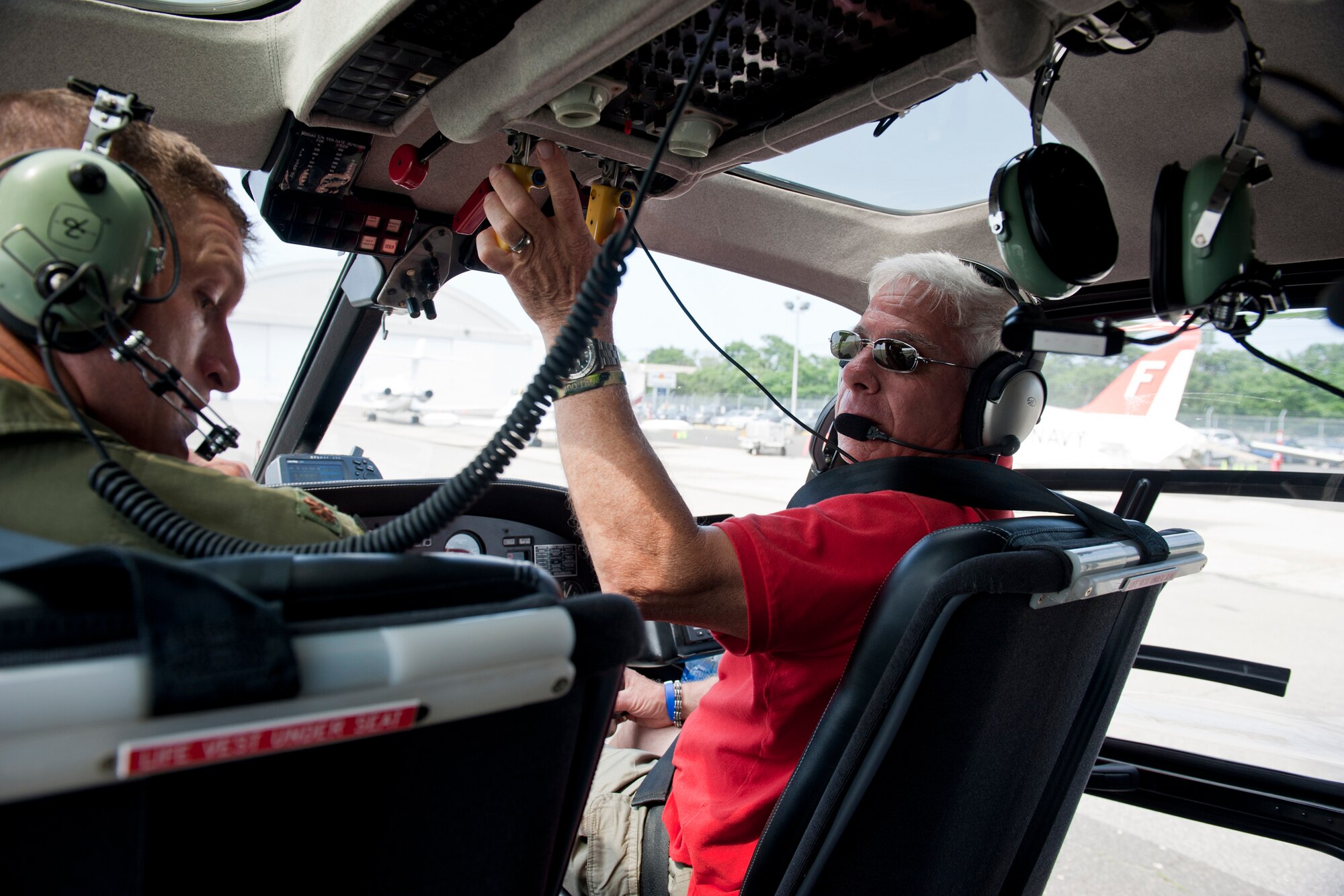 REPUBLIC AIRPORT, N.Y. -- Al Cerullo, aerial cinematographer, and Maj. Dylan Thorpe, A-10 East Demonstration Team pilot, prepare for flight in a helicopter May 28. With a few miles separating Republic Airport and center stage of the air show at Jones Beach, Mr. Cerullo helped the demo team members quickly get back and forth as needed. (U.S. Air Force photo/Staff Sgt. Jamal D. Sutter)(RELEASED)
