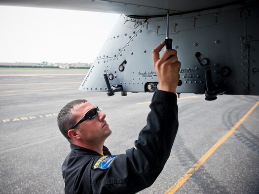 Staff Sgt. Benjamin McIntosh, A-10 East Demonstration Team engine specialist, tightens the screws of an A-10C Thunderbolt II after a successful flight during an air show May 28. After every few flights, the team checked screws in certain areas of the aircraft that could have loosened during the flight. Loosened screws can result in aircraft parts damaging the engines and endangering the pilot. (U.S. Air Force photo by Staff Sgt. Jamal D. Sutter/Released)