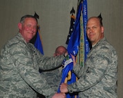 MINOT AIR FORCE BASE, N.D. -- Maj. Gen. Donald Alston, 20th Air Force commander, passes the 91st Missile Wing guidon to Col. Stephen Davis, as he assumes command here June 2. Colonel Davis will serve as the 67th commander of the 91st MW “Roughriders.” The change of command ceremony is one of the Air Force’s time-honored traditions. (U.S. Air Force photo/Senior Airman Michael J. Veloz)