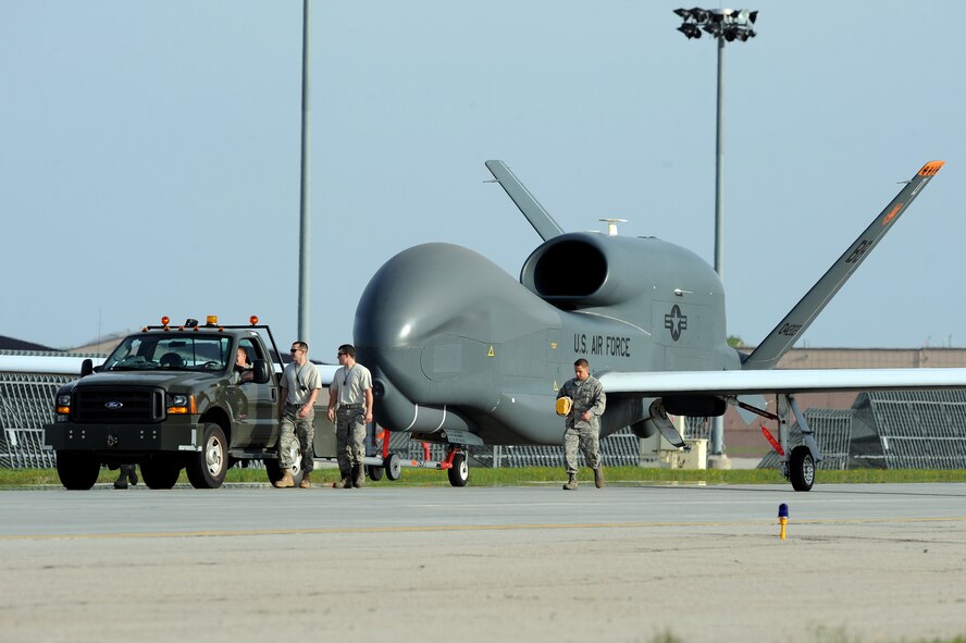 Airmen from Grand Forks Air Force Base welcome the first RQ-4 Global Hawk to the base May 26. The arrival marked the beginning of a new era of remotely piloted aircraft at the base, which will be maintained under Detachment 1, 9th Reconnaissance Wing. (U.S. Air Force photo by Tech. Sgt. Johnny Saldivar)