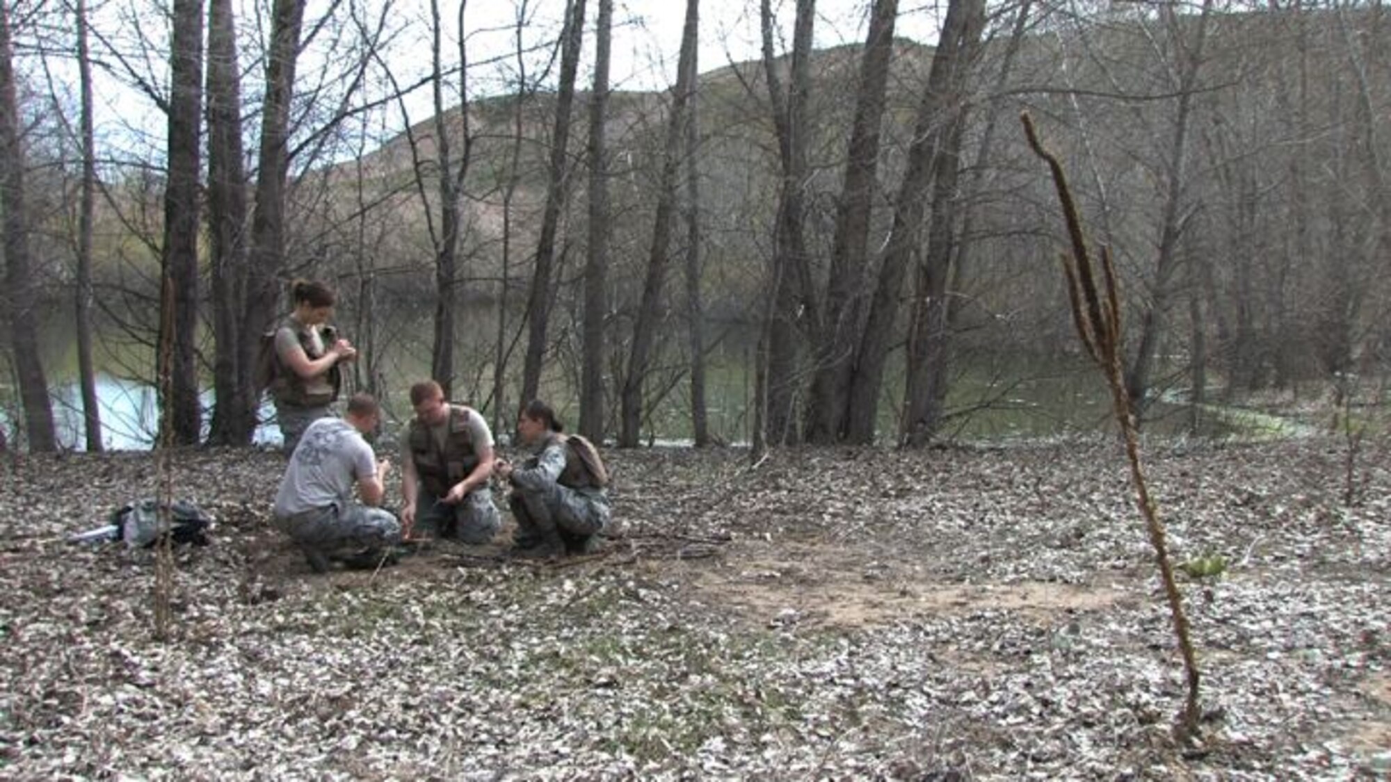 The 934th Operations Group, SERE (Search, Escape, Survival and Evasion) 

instructor, Staff Sgt. Adam Craft conducts survival skill techniques at the Arden 

Hills training area with aircrew members from the 934th Aeromedical 

Evacuation Squadron. Survival skills training is required for all aircrew members. (Air Force Photo/Wendy Cormier)

Their focus was prioritizing their needs, navigation and fire starting techniques.

