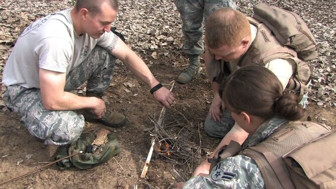 The 934th Operations Group, SERE (Search, Escape, Survival and Evasion) 

instructor, Staff Sgt. Adam Craft conducts survival skill techniques at the Arden 

Hills training area with aircrew members from the 934th Aeromedical 

Evacuation Squadron. Survival skills training is required for all aircrew members. (Air Force Photo/Wendy Cormier)

Their focus was prioritizing their needs, navigation and fire starting techniques.
