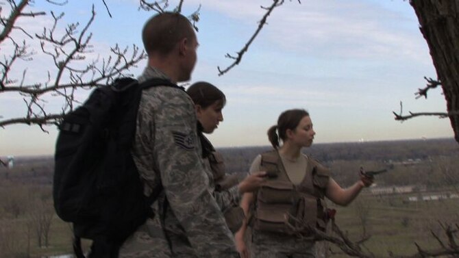 The 934th Operations Group, SERE (Search, Escape, Survival and Evasion) 

instructor, Staff Sgt. Adam Craft conducts survival skill techniques at the Arden 

Hills training area with aircrew members from the 934th Aeromedical 

Evacuation Squadron. Survival skills training is required for all aircrew members. (Air Force Photo/Wendy Cormier)

Their focus was prioritizing their needs, navigation and fire starting techniques.
