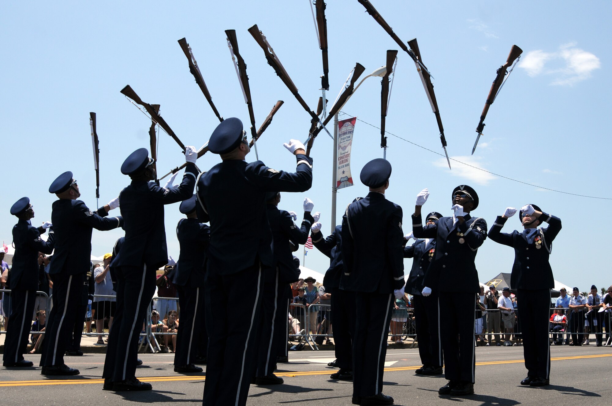 The U.S. Air Force Drill Team throws their M-1 rifles into the air May 28 for the Myrtle Beach, S.C., Memorial Day celebrations. The parade had an expected audience of more than 50,000 people. (U.S. Air Force photo by Airman 1st Class Tabitha N. Haynes)