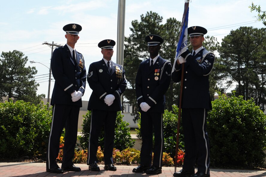 From left to right, Capt. Justin Hochstein, commander of the U.S. Air Force Honor Guard drill team and officer in charge of the parade flight, Tech. Sgt. Kelly McKinley, flight sergeant, Airman 1st Class Lucky Caswell, ceremonial guardsman and native of Columbia, S.C., and Senior Airman John Van Deusen, guidon bearer, gather for a photo May 28 following the USAF Honor Guard parade flight’s participation in the Myrtle Beach, S.C., Memorial Day parade. (U.S. Air Force photo by Airman 1st Class Tabitha N. Haynes)