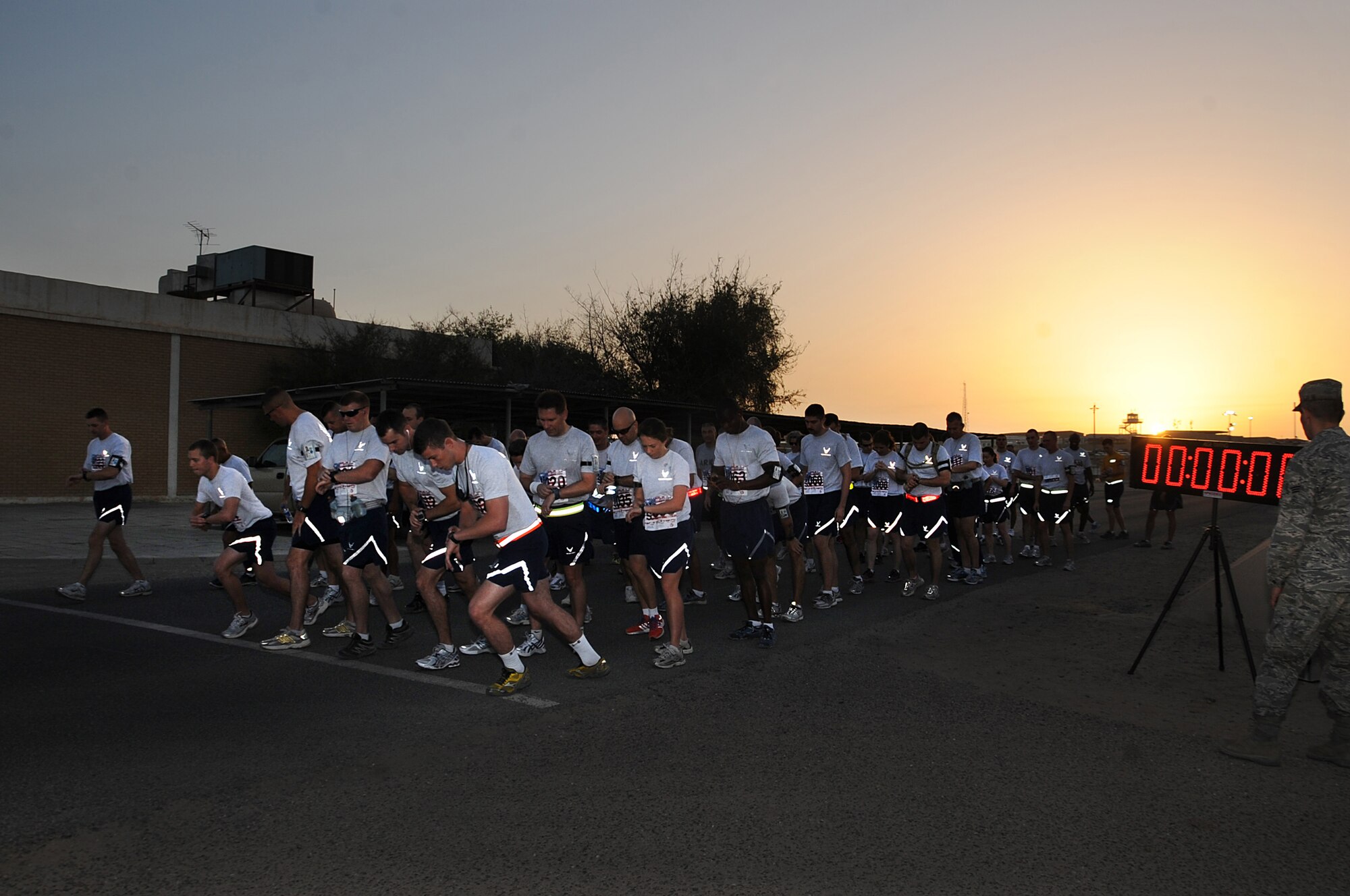 Deployed Airmen with the 386th Air Expeditionary Wing prepare their watches at the start line of the Bolder Boulder run in Southwest Asia May 31.  (U.S. Air Force photo by Senior Airman Cynthia Spalding)