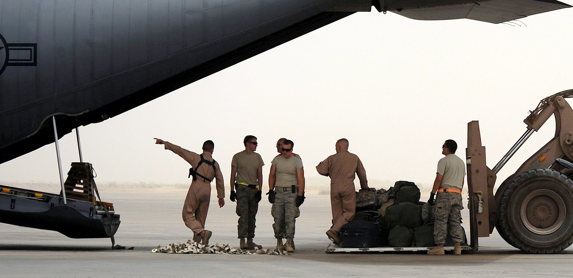 Loadmasters and a crew from the 447th Expeditionary Logistics Readiness Squadron at Sather Air Base, Iraq, load a baggage pallet onto a C-130 Hercules June 3, 2008. Sitting on the C-130's cargo ramp is a "milkstool": a ramp support platform that may, in coming years, be replaced with a more lightweight version designed by Air Force Academy cadets. (U.S. Air Force photo/Tech. Sgt. Jeffrey Allen)