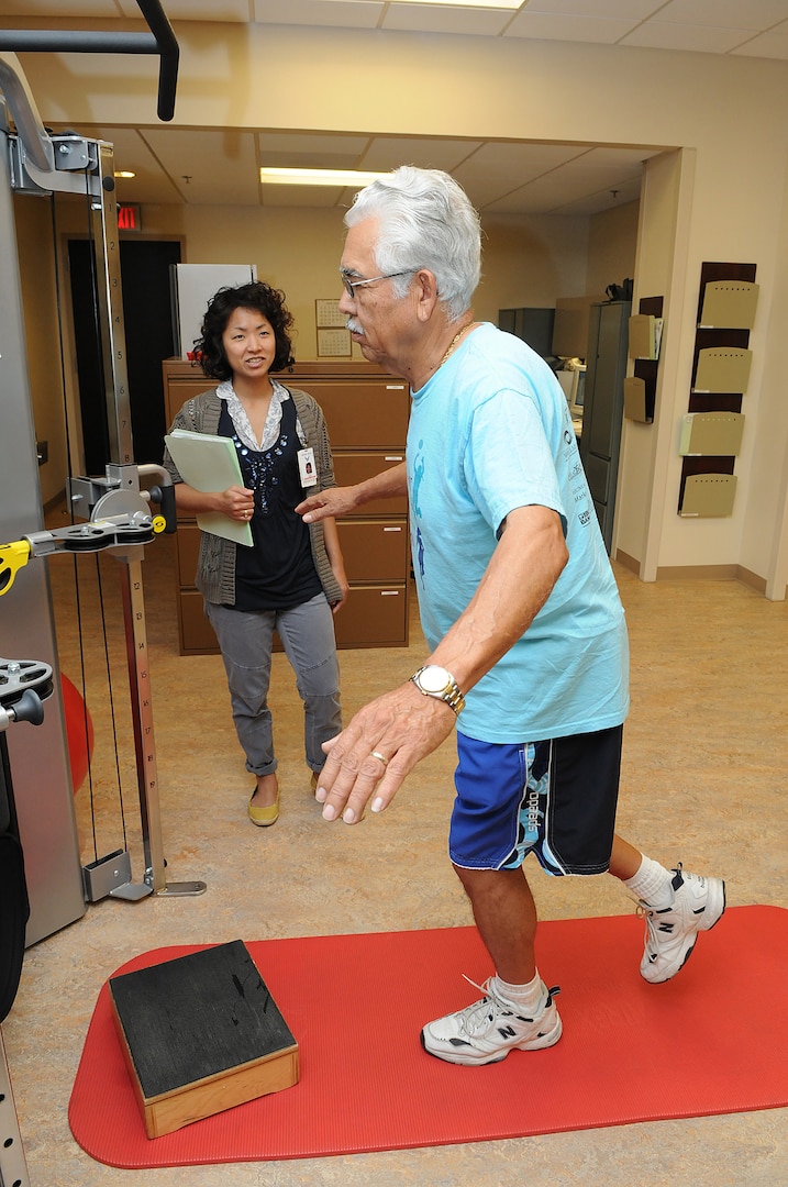 Physical therapist Harmony Choi observes patient  Faustino "Tino" Gomez during therapy at the Physical Therapy Clinic on Randolph Air Force Base, Texas. Gomez is a retired U.S. Army 1st Sergeant who is participating in a study on knee osteoarthritis. (U.S. Air Force photo/David Terry)