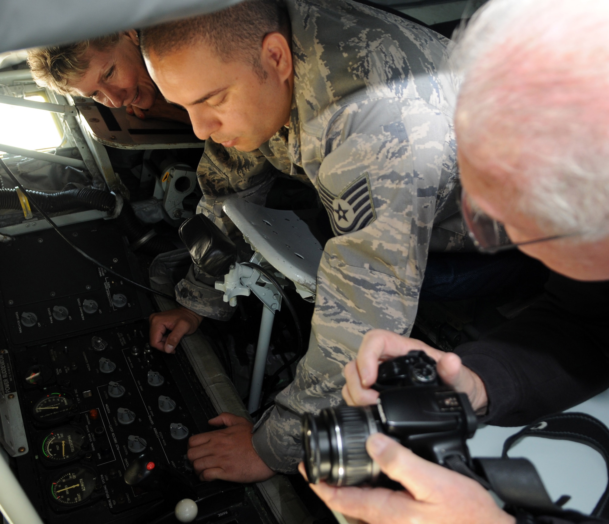 RAF MILDENHALL, England -- Tech. Sgt. Roger Vula (center), 351st Air Refueling Squadron boom operator, explains how he transfers fuel from a KC-135 Stratotanker to a receiver aircraft when aerial refueling, to former members of the 91st Bomber Group during a base visit here June 1, 2011. The base visit included a 3rd Air Force mission brief, a KC-135 and an MC-130H Combat Talon II static display. (U.S. Air Force photo/Senior Airman Rachel Waller)  