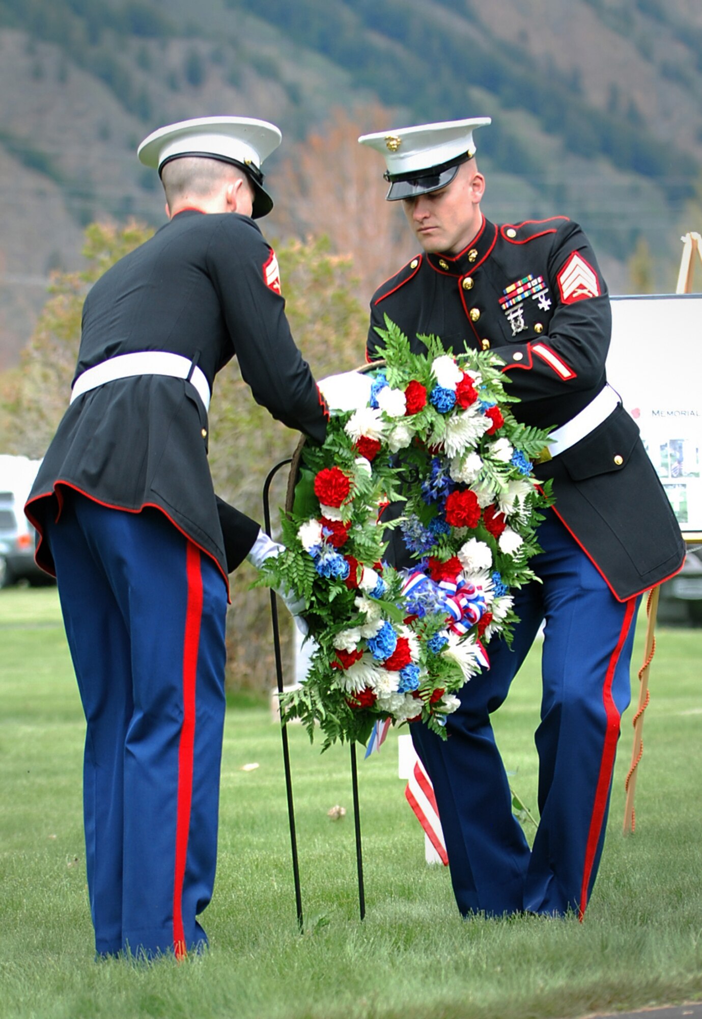 HAILEY, Idaho – Sgt. David Scholl and Cpl. Matthew Snyder, U.S. Marine Corp Inspector Instructor Staff Company C, 4th Tank Bn, Boise, ID, present a wreath at the Hailey Cemetery Grave of the Unknown Soldier for the Memorial Day service May 30.  (U.S. Air Force photo by Master Sgt. Andrew Leonhard)