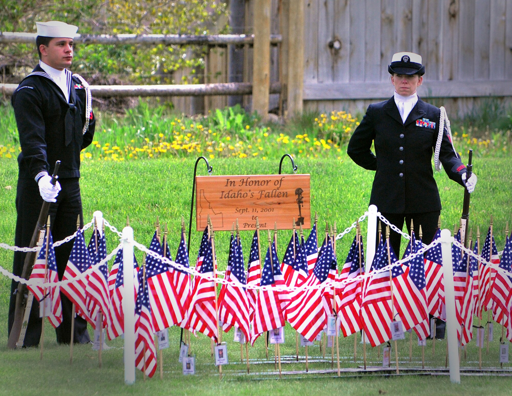 HAILEY, Idaho – Petty Officer 2nd Class Eric Munoz and Petty Officer 1st Class Allisandra Denson of the Navy Operational Support Center in Boise, Idaho, stand watch over the display of flags in honor of the fallen military personnel of Idaho since Sept. 11, 2001.  The display was part of the Memorial Day service at the Hailey Cemetery May 30.  More than 400 people attended the ceremony, to include past and present service personnel from all Department of Defense military branches. Col. James McClellan, 366th Maintenance Group commander, was the keynote speaker.  Retired U.S. Air Force Col. Gail Halvorsen, Berlin Airlift Candy Bomber, was also in attendance. (U.S. Air Force photo by Master Sgt. Andrew Leonhard)