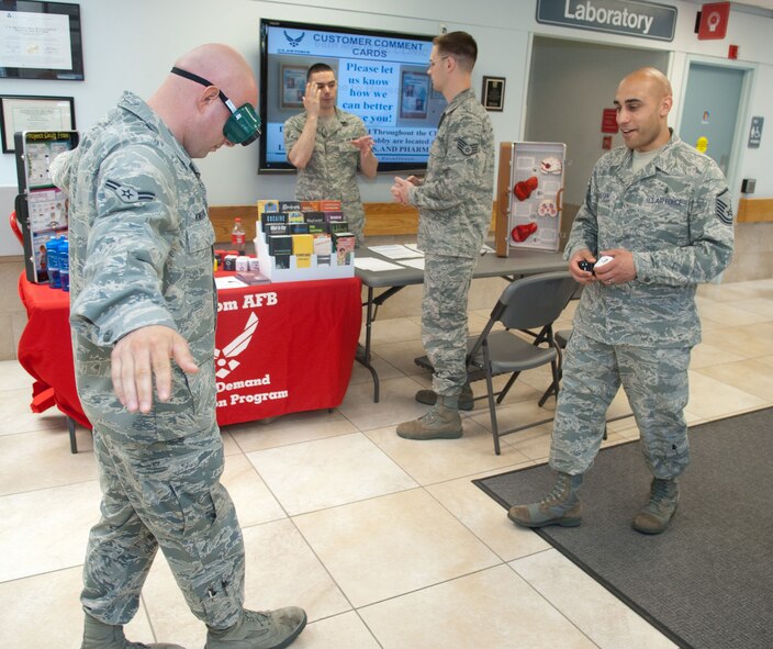 HANSCOM AIR FORCE BASE, Mass. – Master Sgt. David Hassan (right), NCOIC of the Mental Health Flight gives a sobriety test to Airman 1st Class Scott Knighton as he wears beer goggles May 26. Members of Mental Health, Family Advocacy, ADAPT and Drug Demand Reduction programs were at the Brown Building and 66th Medical Squadron Clinic to give out information about alcohol and substance abuse as part of Alcohol Awareness Day. (U.S. Air Force photo by Rick Berry)
