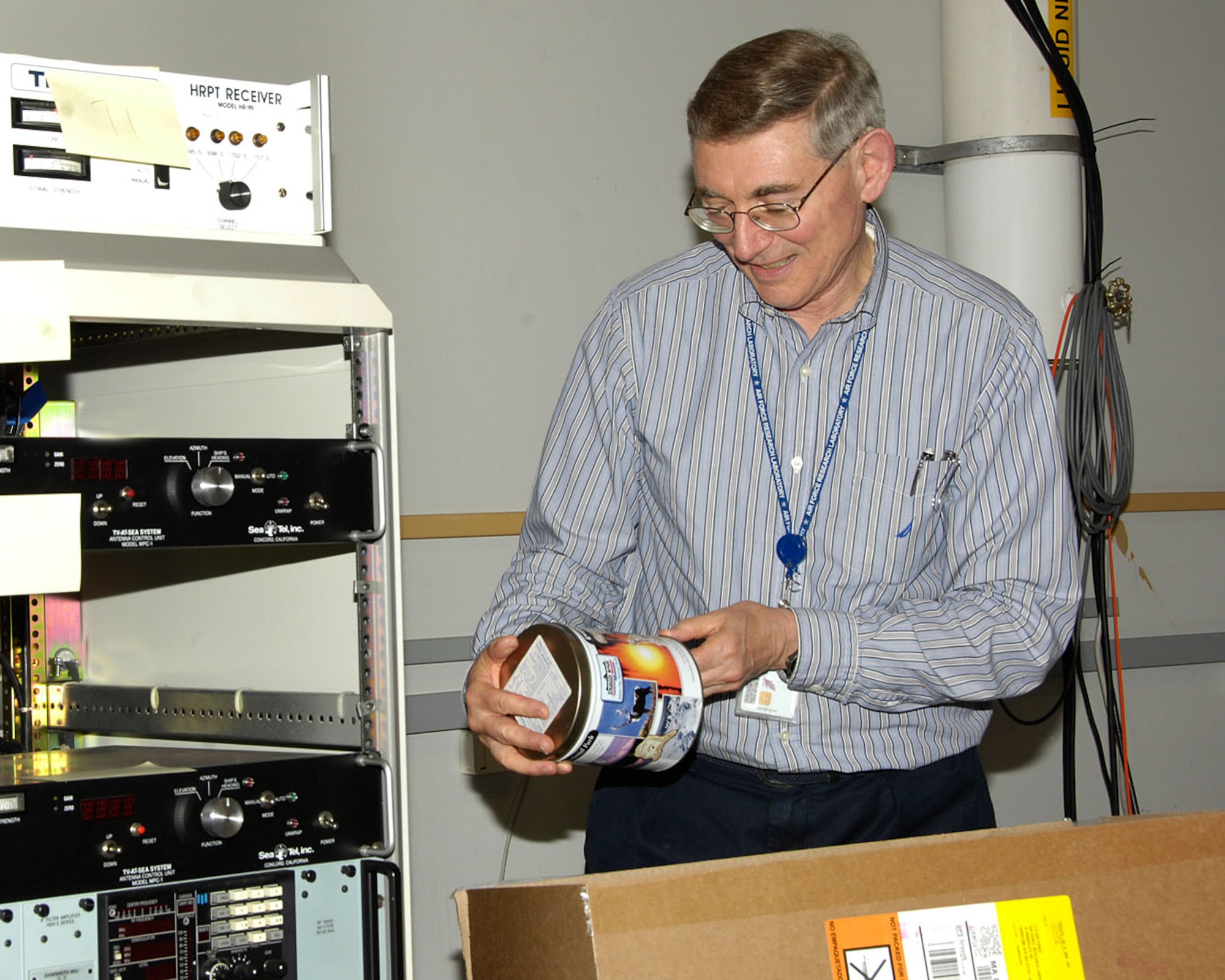 HANSCOM AIR FORCE BASE, Mass. – Dr. George Jumper, Air Force Research Laboratory’s Defensive Space Control Foundations section chief, packs up books and equipment from the Environmental Satellite Data Facility June 1. The facility at one time received data from three weather satellite systems using very large antennae on the roof. The satellite data and other weather information were processed by the computers that were in the room, and the results of many years of information have been archived on terabytes of data storage systems. (U.S. Air Force photo by Linda LaBonte Britt)
