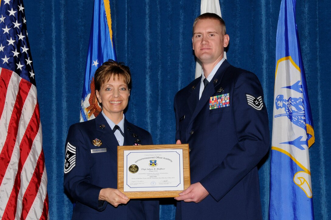 McGHEE TYSON AIR NATIONAL GUARD BASE, Tenn. - Air Force Tech. Sgt. Adam R. Haffner, right, receives the distinguished graduate award for NCO Academy Class 11-4 at The I.G. Brown Air National Guard Training and Education Center here from Chief Master Sgt. Denise Jelinski-Hall, May 20, 2011.  The distinguished graduate award is presented to students in the top ten percent of the class.  It is based on objective and performance evaluations, demonstrated leadership, and performance as a team player. (U.S. Air Force photo by Master Sgt. Kurt Skoglund/Released)