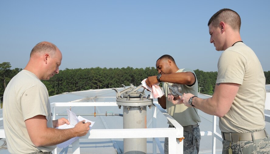 SEYMOUR JOHNSON AIR FORCE BASE, N.C.- Master Sgt. Timothy Whitt evaluates Staff Sgts. Tyrone Mallard and Jeremy Varney during the tank gauging event as part of the Wing Turkey Shoot here, May 25, 2011. The event tests the ability of technicians to accurately inventory the fuel storage tank level. Master Sgt. Whitt is the 4th Logistic Readiness Squadron section chief of the fuels information service center and is from Latham, Ohio. Sergeant Mallard, 4th Logistic Readiness Squadron fuels distribution supervisor, is from Hickory. Sergeant Varney, 4th Logistic Readiness Squadron fuels distribution supervisor, is from Dudley.  (U.S. Air Force photo/Senior Airman Whitney Lambert)
