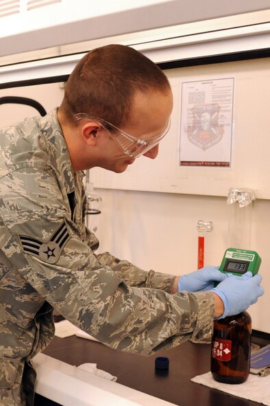 SEYMOUR JOHNSON AIR FORCE BASE, N.C.- Senior Airman Jessie Carter checks a quart fuel sample for conductivity additive levels using a conductivity meter during the lab sampling challenge as part of the Wing Turkey Shoot here, May 25, 2011.  The test is done to ensure the fuel has proper levels of additives to dissipate static electricity during movement. Airman Carter, 4th Logistic Readiness Squadron fuels distribution operator is from Gate City, Va. (U.S. Air Force photo/Senior Airman Whitney Lambert)