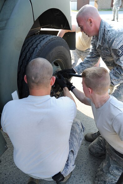 SEYMOUR JOHNSON AIR FORCE BASE, N.C.- Fuels technicians from the 4th Logistic Readiness Squadron remove lug nuts from a tire of an R-11 refueling truck during a tire change challenge here May 25, 2011. The tire change challenge was a timed event of the Wing Turkey Shoot where fuels technicians work as a team to demonstrate their ability to safely change a tire on the R-11 refueling unit. (U.S. Air Force photo/Senior Airman Whitney Lambert)(RELEASED)