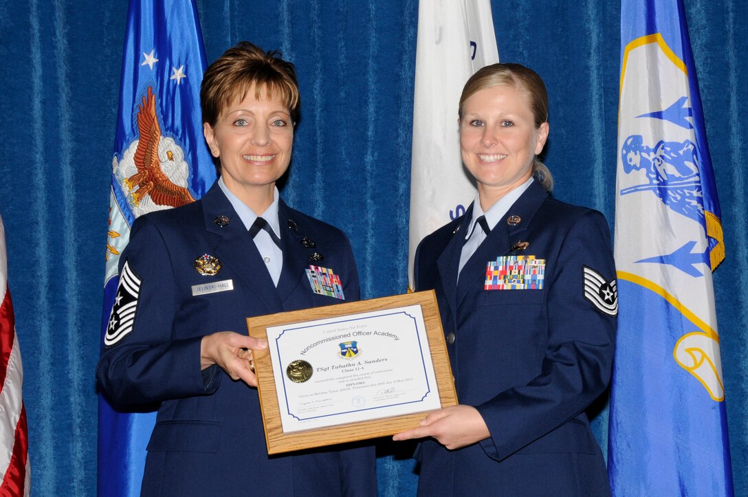 McGHEE TYSON AIR NATIONAL GUARD BASE, Tenn. - Air Force Tech. Sgt. Tabatha A. Sanders, right, receives the distinguished graduate award for NCO Academy Class 11-4 at The I.G. Brown Air National Guard Training and Education Center here from Chief Master Sgt. Denise Jelinski-Hall, May 20, 2011.  The distinguished graduate award is presented to students in the top ten percent of the class.  It is based on objective and performance evaluations, demonstrated leadership, and performance as a team player. (U.S. Air Force photo by Master Sgt. Kurt Skoglund/Released)