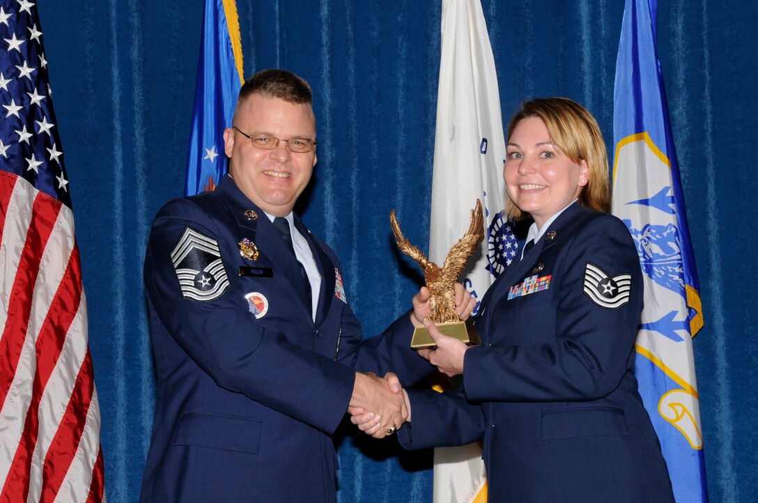 McGHEE TYSON AIR NATIONAL GUARD BASE, Tenn. - Air National Guard Tech. Sgt. Kristin J. Martin, right, receives the commandant award for NCO Academy Class 11-4 at The I.G. Brown Air National Guard Training and Education Center here from Chief Master Sgt. Donald E. Felch, EPME commandant, May 20, 2011.  The award is presented to the student who made the most significant contribution to the overall success of the class by demonstrating superior leadership abilities and excellent skills as a team member.  It is named in honor of CMSgt Paul H. Lankford, a Bataan Death March survivor and the first commandant of the Air National Guard Enlisted Professional Military Education Center.  (U.S. Air Force photo by Master Sgt. Kurt Skoglund/Released)
