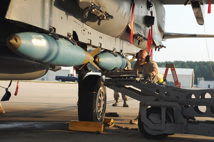 SEYMOUR JOHNSON AIR FORCE BASE, N.C.- Tech. Sgt. Troy Jacobsen ensures a bomb is properly secured to an F-15E Strike Eagle during a weapons load competition here, May 25, 2011. The event was part of the Wing Turkey Shoot competition and identified the top weapons load team from each aircraft maintenance unit. Sergeant Jacobsen hails from Sidney, Neb., and is a 4th Aircraft Maintenance Squadron weapons load team chief. (U.S. Air Force photo/Senior Airman Whitney Lambert)(RELEASED)