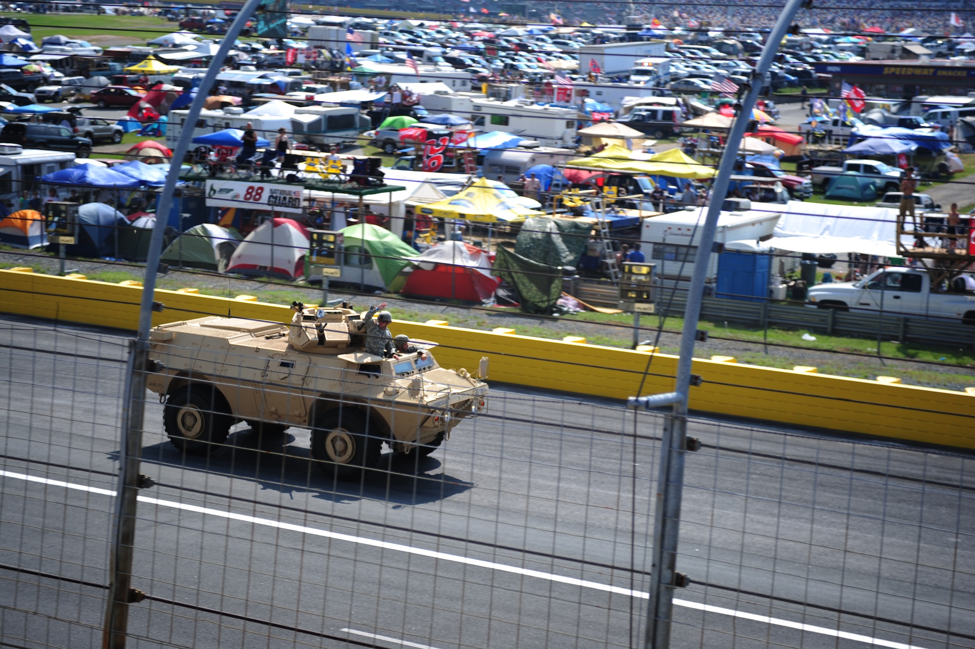 CHARLOTTE MOTOR SPEEDWAY, N.C. - Soldiers from Fort Bragg, N.C., complete a "victory lap" after performing a simulated invasion during opening ceremonies of the Coca-Cola 600 here, May 29, 2011. As part of NASCAR's Memorial Day tribute military members received free tickets to the track's two-week long events. (U.S. Air Force photo/Senior Airman Rae Perry)(RELEASED)