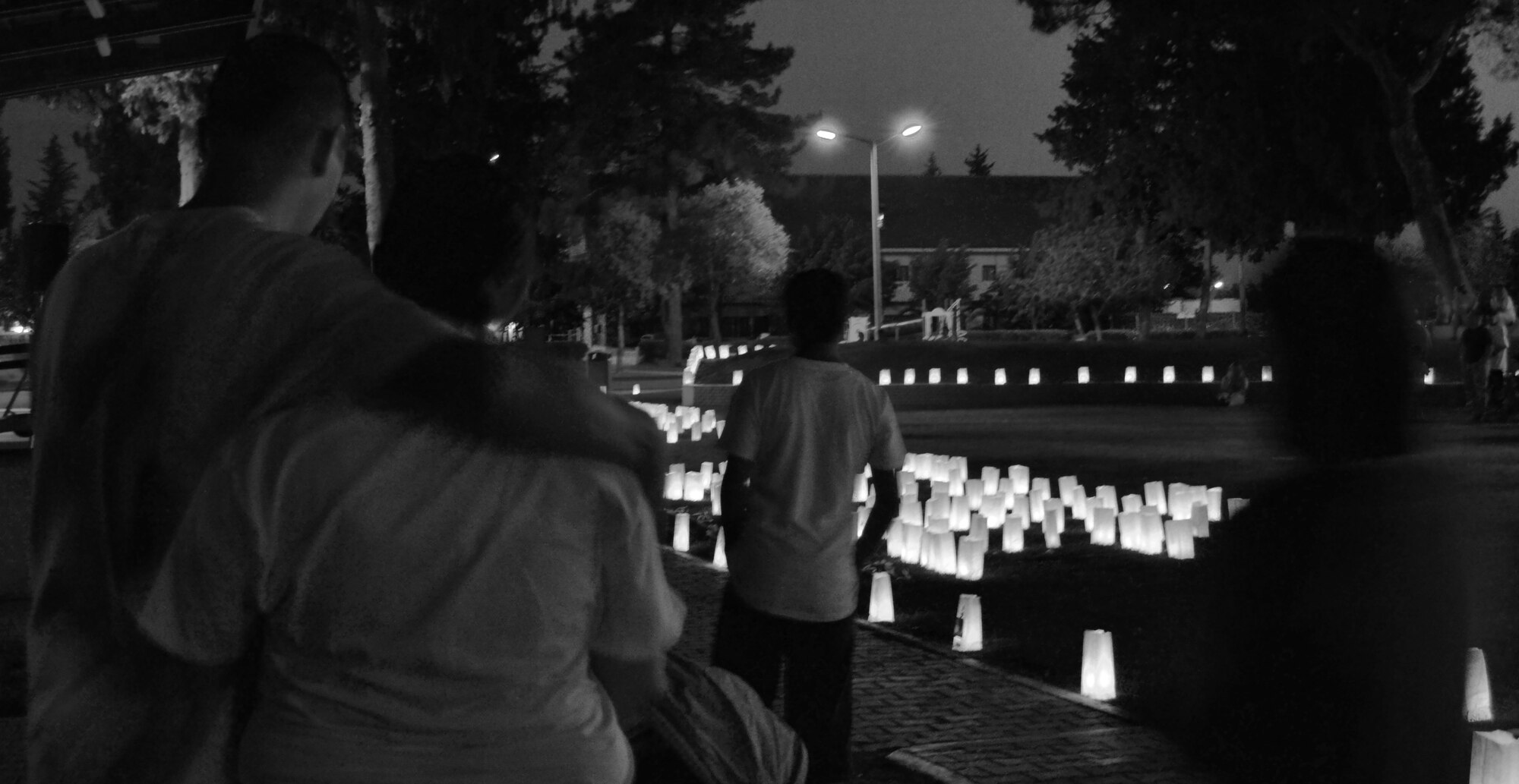 Members of the Incirlik Community take photos and video of the luminaries they created for survivors and victims of cancer during the Relay for Life event held at Arkadas Park May 21, 2011 at Incirlik Air Base, Turkey. Incirlik raised $21,824 in contributions this year. The relay helped raise money for cancer research and cancer patients. The event is held to spread cancer awareness, celebrate the lives of survivors and remember those who lost their lives to cancer. To end the event, families and friends decorated paper bags filled with sand and a candle to illuminate the bag. (U.S. Air Force photo by Staff Sgt. Alexandre Montes/ Released)