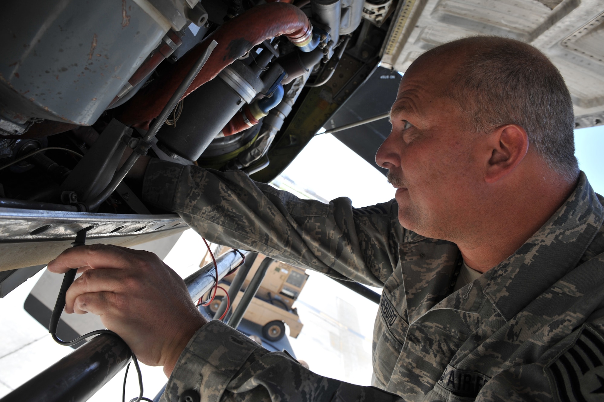 Tech. Sgt. Donald Debord, 455th Expeditionary Aircraft Maintenance Squadron crewchief, inspects an engine cowling during a routine inspection on a C-130 Hercules at Bagram Airfield, Afghanistan, June 2, 2011. Sergeant Debord is deployed from the 166th Aircraft Maintenance Squadron, Delaware Air National Guard, Del., and is a native of New Castle, Del.  (U.S. Air Force photo by Senior Airman Sheila deVera)
