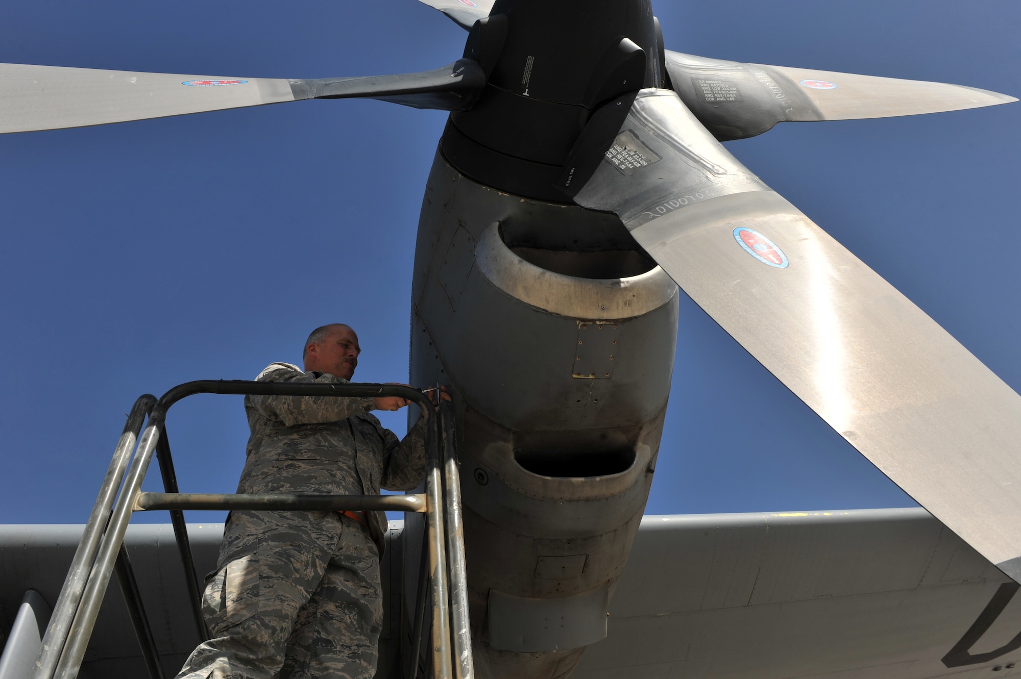 Tech. Sgt. Donald Debord, 455th Expeditionary Aircraft Maintenance Squadron crewchief, opens an engine cowling during a routine inspection on a C-130 Hercules at Bagram Airfield, Afghanistan, June 2, 2011. Sergeant Debord is deployed from the 166th Aircraft Maintenance Squadron, Delaware Air National Guard, Del., and is a native of New Castle, Del.  (U.S. Air Force photo by Senior Airman Sheila deVera)